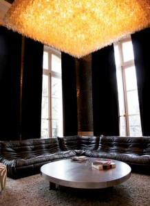 Kravitz’s Paris sitting room features Highway 66 wallpaper from Flavor Paper; a Venini glass chandelier originally made for the Har Mar Theater in St. Paul, Minnesota; a Ligne Roset Togo sofa; and Aldo Chale’s cast-aluminum coffee table with steel legs.