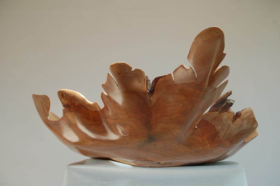 The cherry bowl, made of highly polished wood.